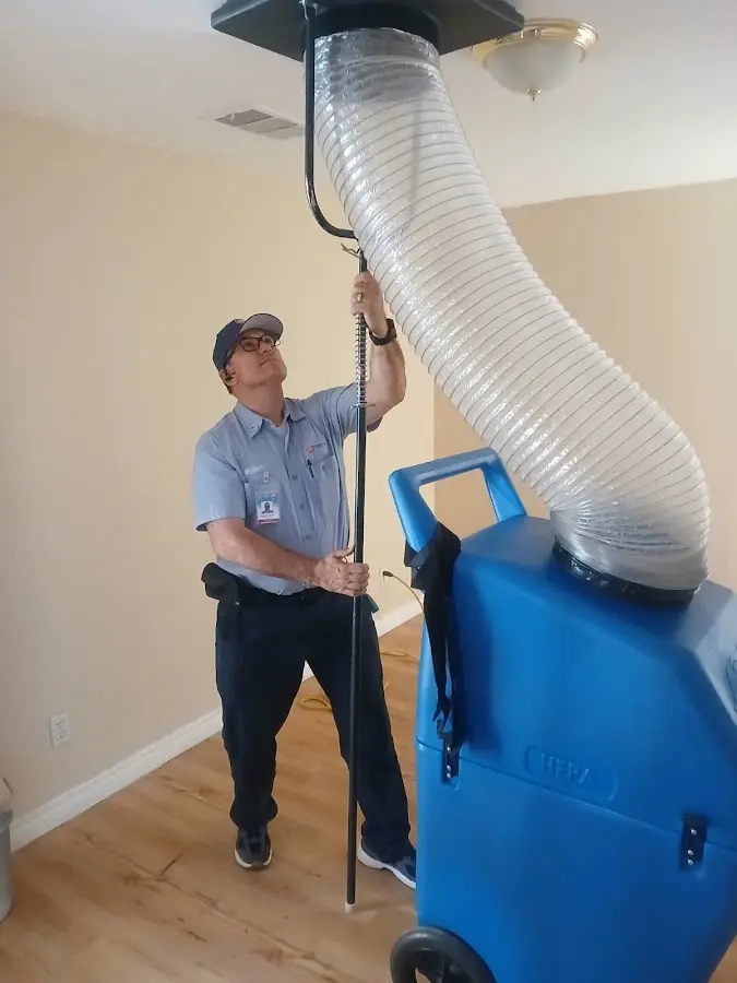 Furnace Tune-Up technician using HEPA equipment in Houma